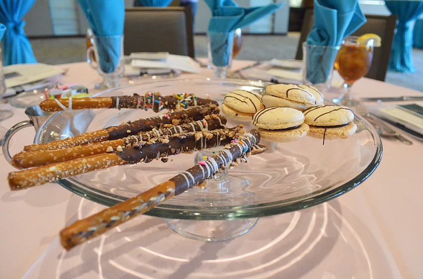 Guests were tempted with dessert trays of vanilla and chocolate macarons with frosted pretzels.