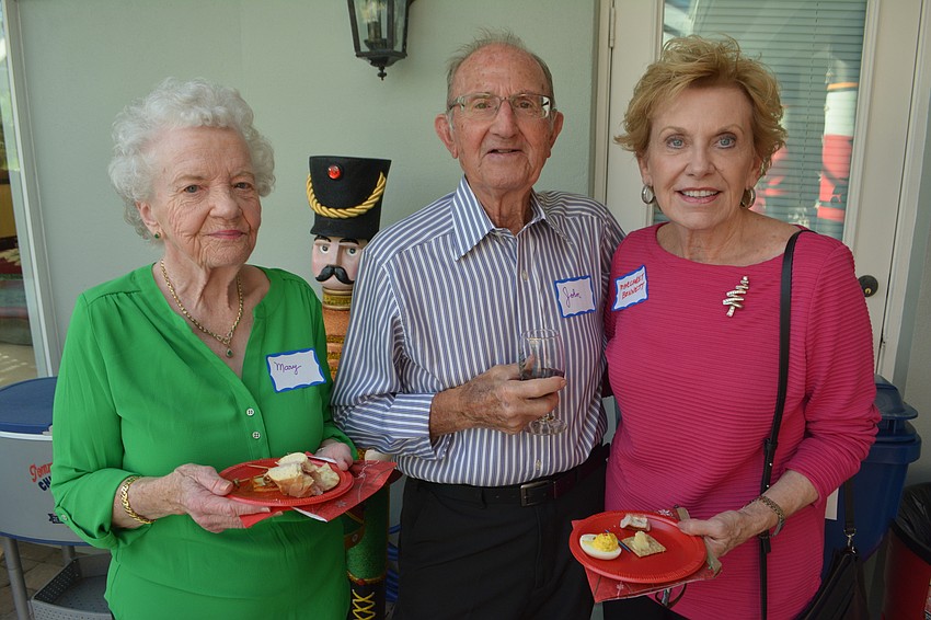 Mary and John Amanti chat with Margaret Bennett at the Holly Jolly.