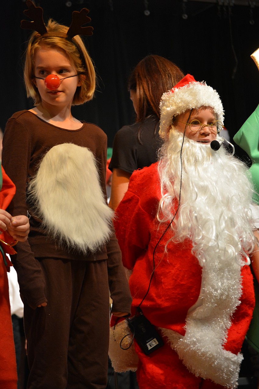 Rudolph (Morgan Cunningham) liked both colors, but Santa (Cooper Leiberick) prefers red.