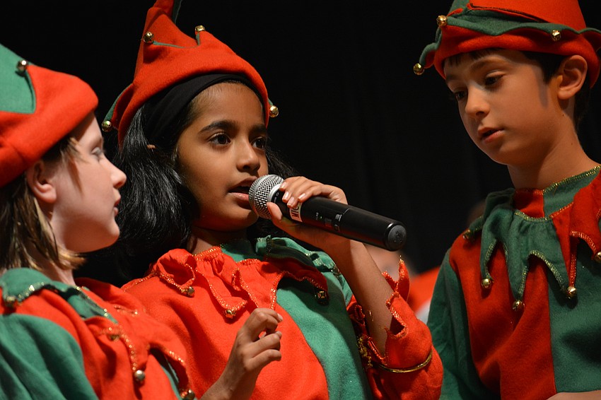 Moksha Pitchala, center, and fellow elves Eva Smith, left, and Gavin Messner, right, help with the who-is-better question.