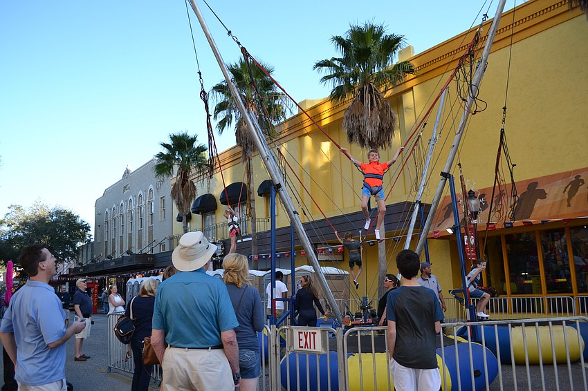 Caleb Overholt looks down to see how far he'  s climbed.