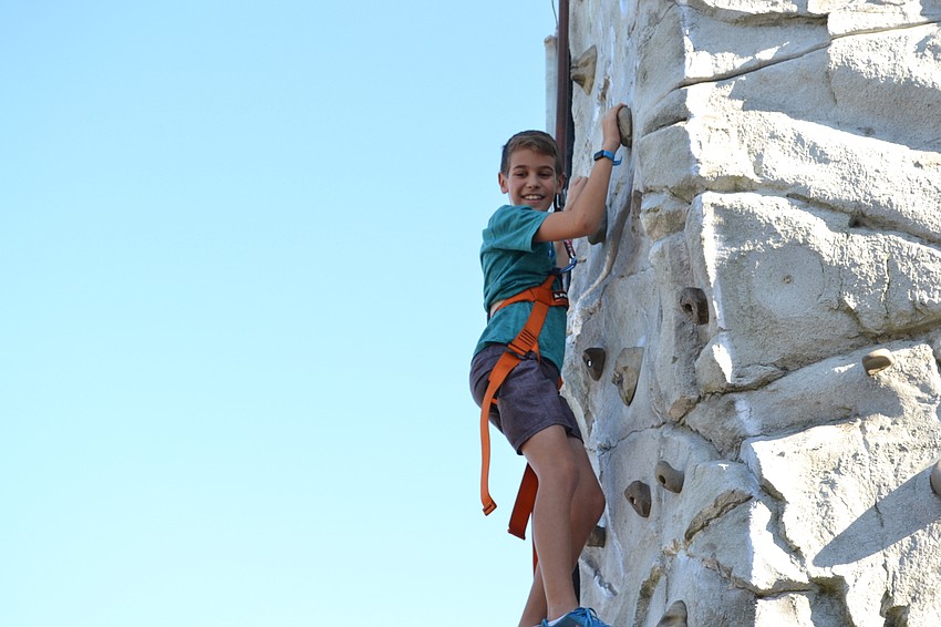 Dana Till takes a spin on a dinosaur ride.