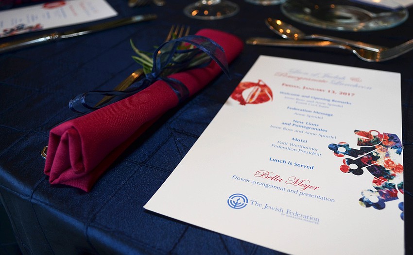 Each table setting included a napkin with a floral arrangement.