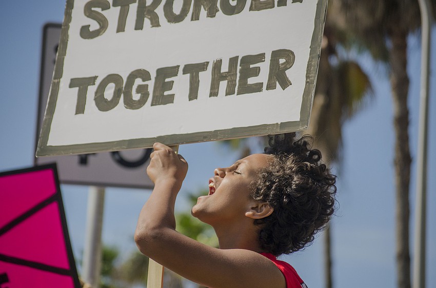 Mikael Tafesse shouts as cars driving along the Ringling Causeway honk in agreement with demonstrators.