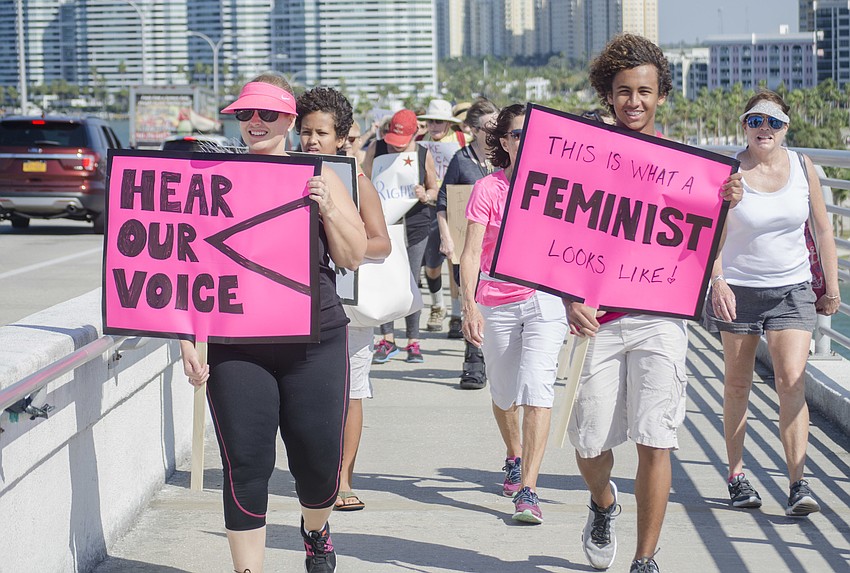 Dawn Lewis and Dawit Tafesse walk across the Ringling Bridge.