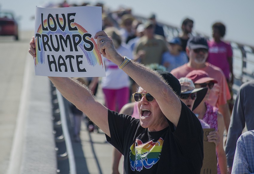 Clark West shouts as a car honks in agreement.