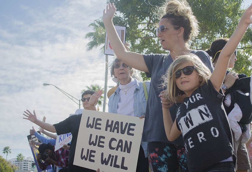 Demonstrators line the street along Bayfront Drive.