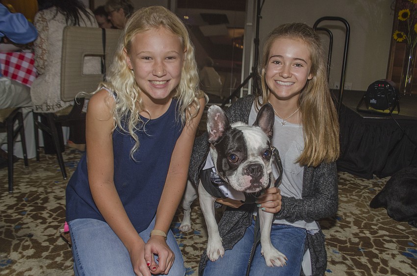 Reagan Walter and Juliana Howe pose with Gus.