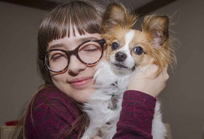Hannah Paley hugs her dog Pumpkin.