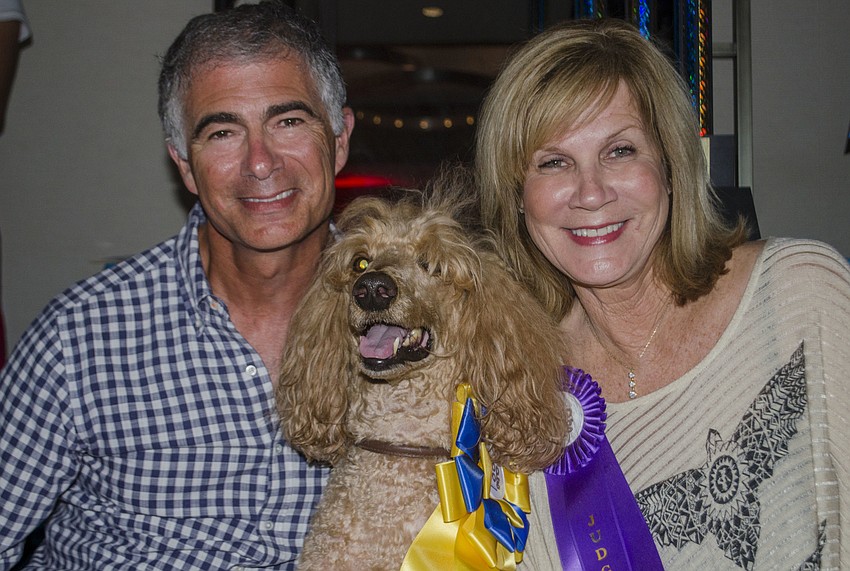 Tony Natale and Manatee County Commissioner Carol Whitmore, who judged the best hair portions of the Top Dog dog show, pose with Natale’s dog Dante, the winner of the best hair competition.