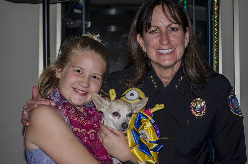 Lilah Davenport and dog Bruce, winners of the best kisser portion of the Top Dog dog show, pose with judge Bradenton Police Chief Melanie Bevan.