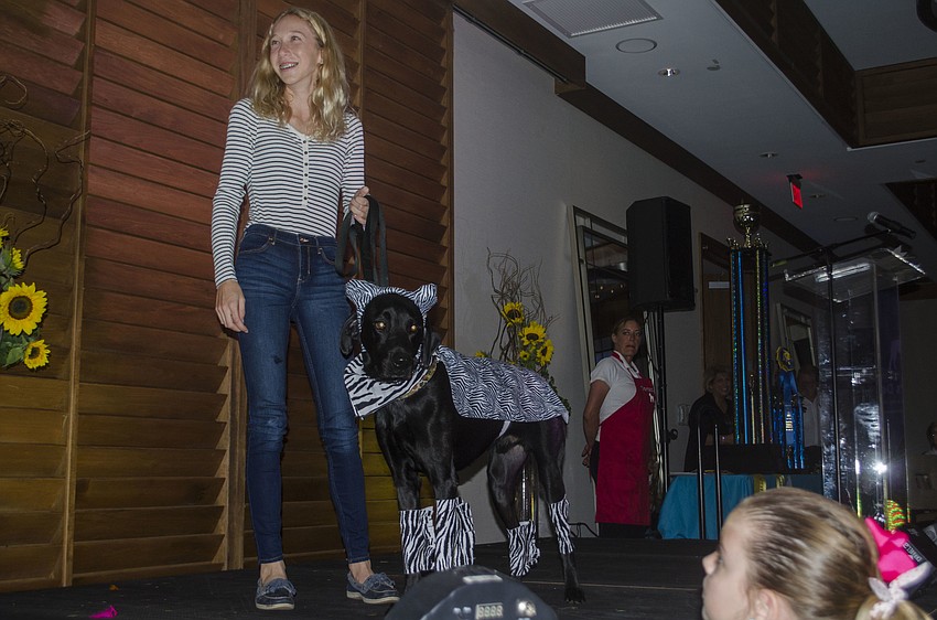 Lucy Walter walks Beau across the stage during the costume portion of the Top Dog dog show.