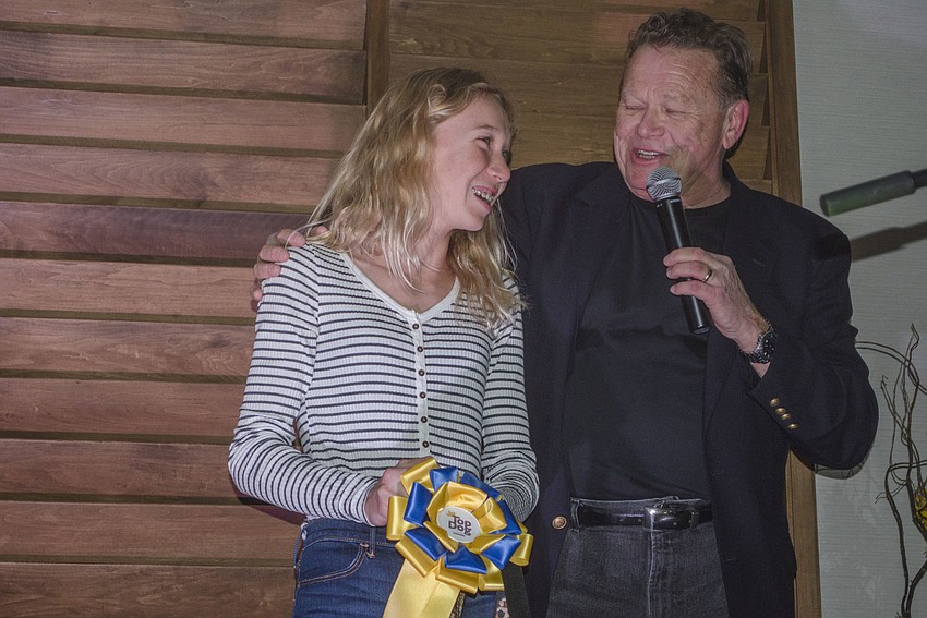 Lucy Walter smiles after her dog Beau won the overall Top Dog award.