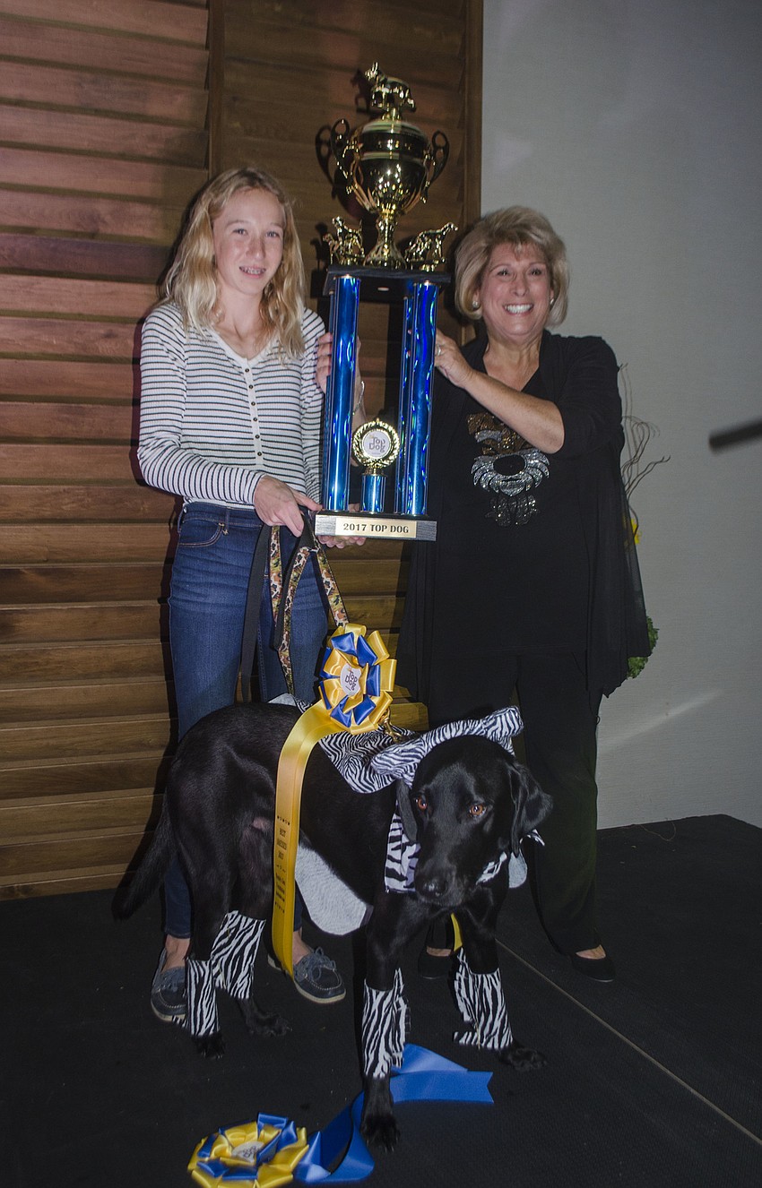 Lucy Walter poses with Donte’s Den Founder Marsha Panuce and dog Beau after Beau won the overall Top Dog award.