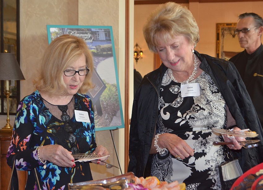 Sydney McSweeney and Elaine Steinfurth, both members of the Women'  s Charitable Fund, explore their food choices.