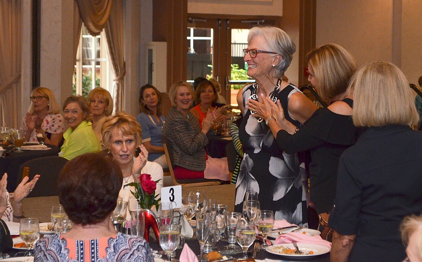Eileen Cantarella smiles as guests applaud her and the other committee members who planned the event.