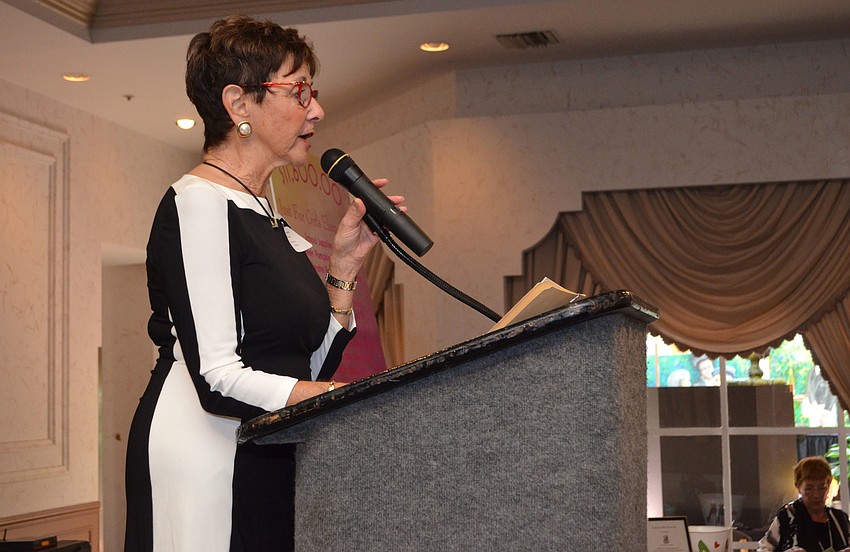 University Park Women’s Club President Maria Van Brunt welcomes the crowd.