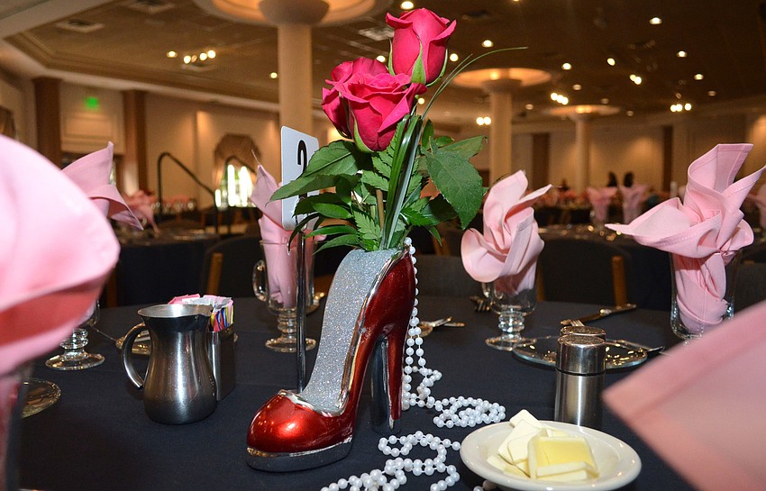 Every table in the Michael’s On East ballroom was adorned with glittering high heel-shaped vases, roses and pearls Feb. 8.