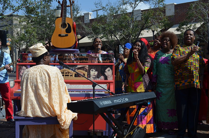 Henry Porter plays a piano designed by local artist Jack Dowd.