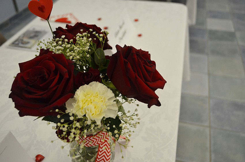 Roses and other flowers rested on tables around the parish hall.
