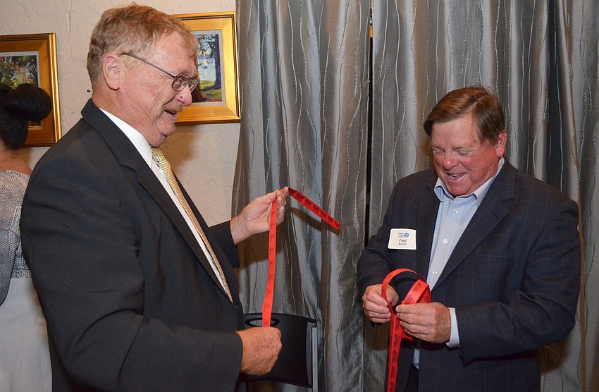 Al Capter and Fred Murrell give out raffle tickets.