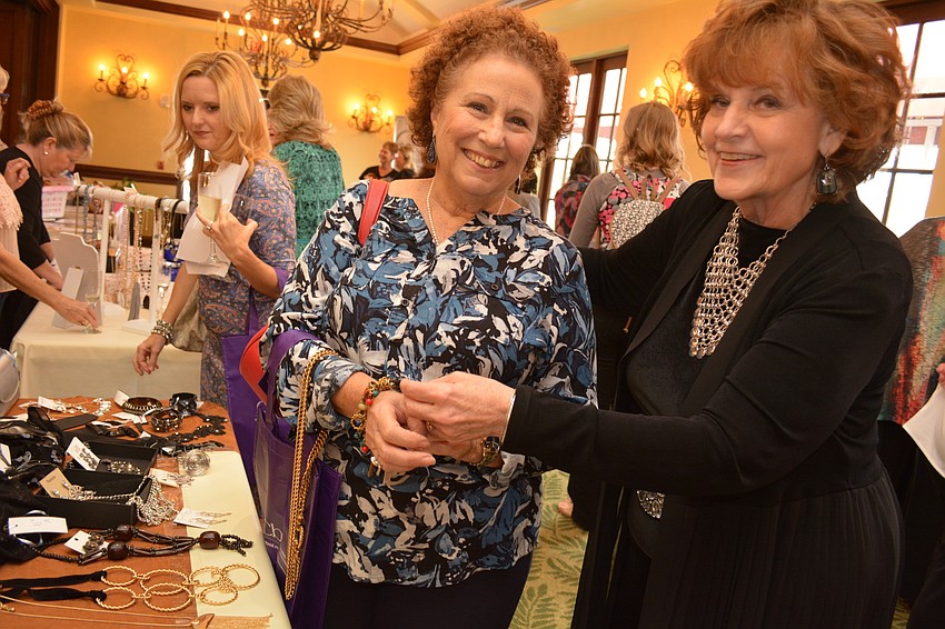 Cascades resident Carline Zumbano tries on jewelry featured by Sharon Steward, of First Impressions Image Consulting, in East County.