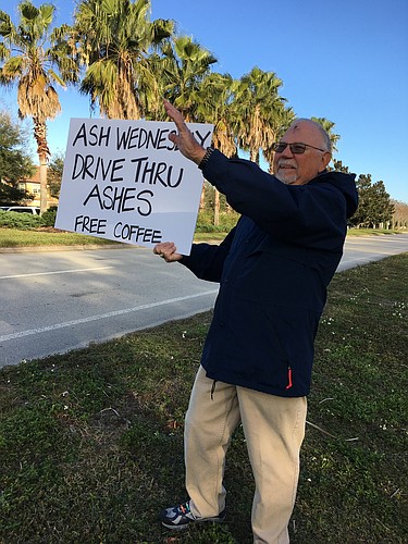 A volunteer holds a sign for last year&#39;   s "drive thru ashes" event. Courtesy photo.