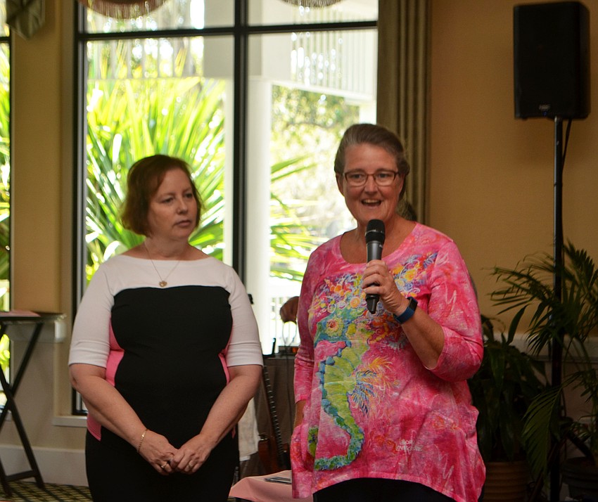 Barb Genneken and Suellen Kaeb of Breast Health Sarasota Inc. talk to the crowd at the women’s golf associations’ annual Go for the Cure event on Feb. 28.