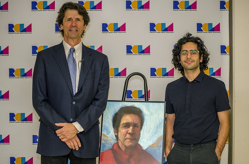 James Balog and Ringling College of Art and Design senior Nickolas Archilla pose with the portrait of Balog.