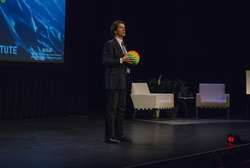 James Balog used a volleyball to illustrate the scientific truth of gravity before introducing the topic of his lecture — climate change.