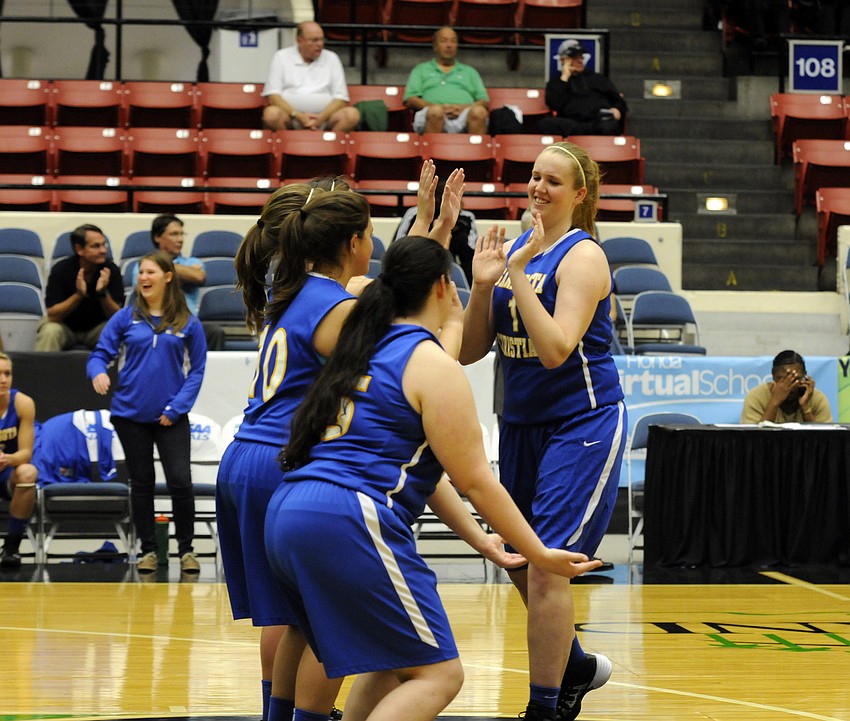 Anikka Jensen high fives her teammates before the start of the FHSAA Class 2A state championship Feb. 20.