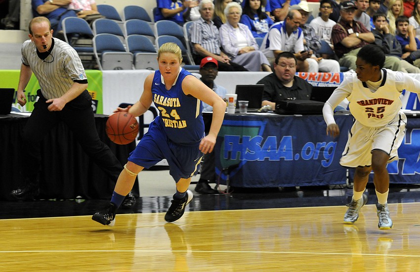 Sarasota Christianâ€™s Megan Garriott pushes the ball down the court in the first quarter.