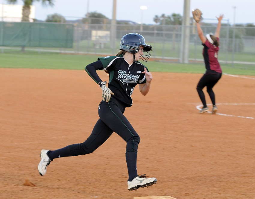 Pinch runner Sierra Schappacher rounds third base and heads for home plate in the fifth inning.