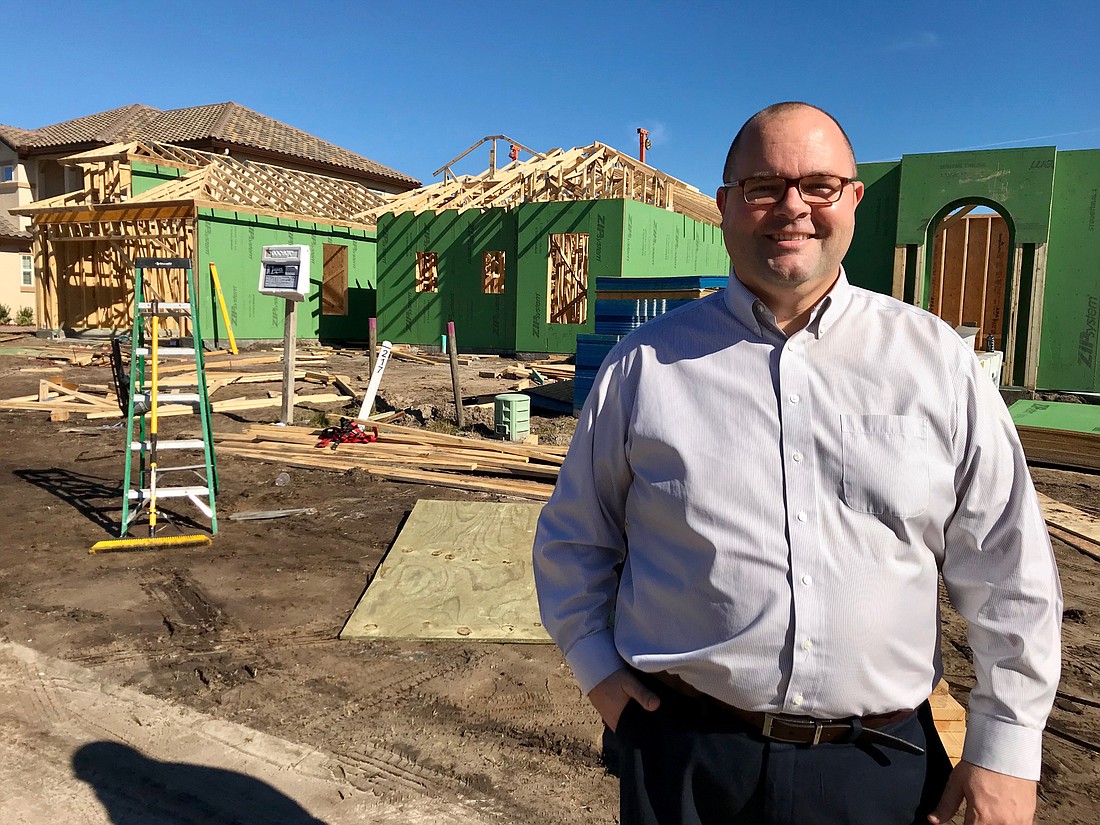 Joe Blanco, the division president of ICI Homes, stands in front of a home under construction in the Tamaya community near Beach and Kernan boulevards in Jacksonville.