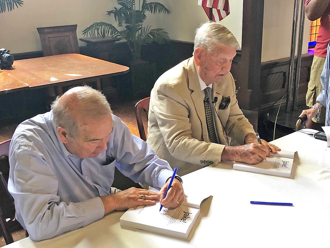Author Mike Tolbert and former Mayor Jake Godbold sign the biography â€œJake!â€ on Wednesday at Old St. Andrews Church.