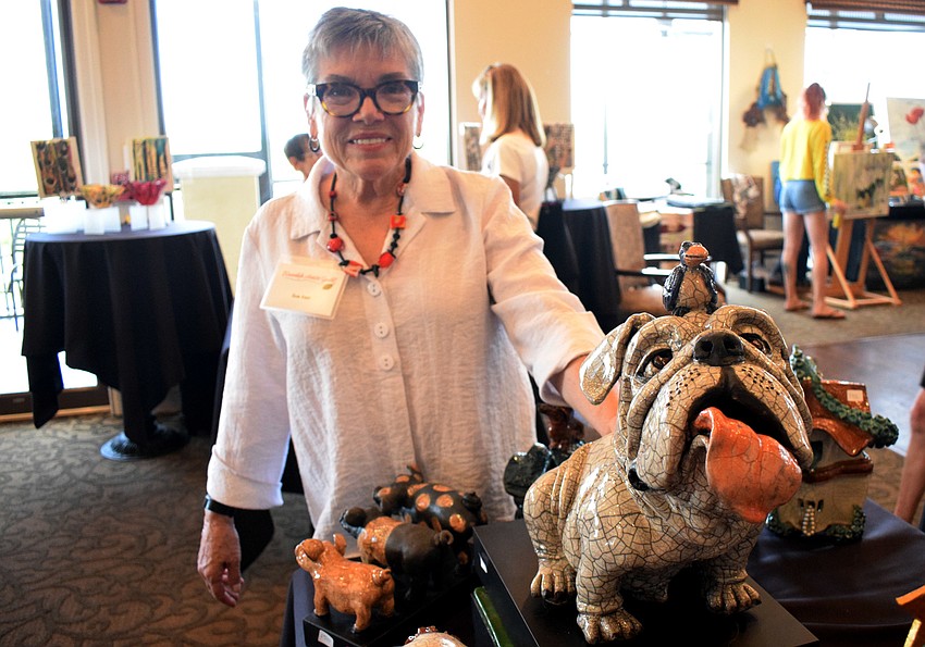 Waterlefe's Sue Kerr shows off the dog she made using raku firing.