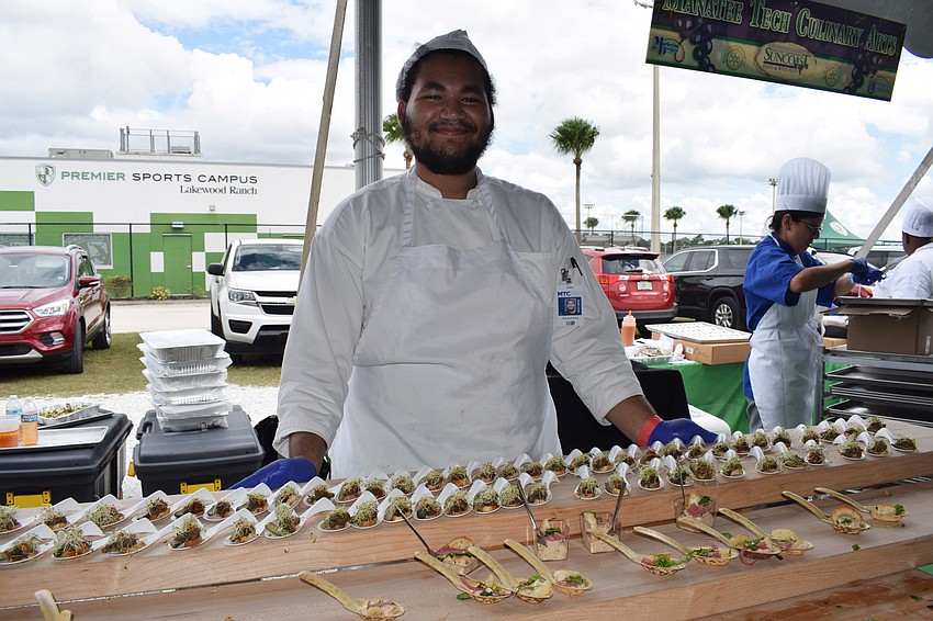 Maxwell King, a culinary student at Manatee Technical College, serves beef tartare and smoke salmon mousse.