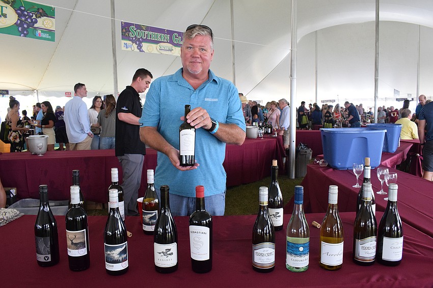 Dave Milne with Southern Glazer's Wine and Spirits shows the different wines available for people to sample.