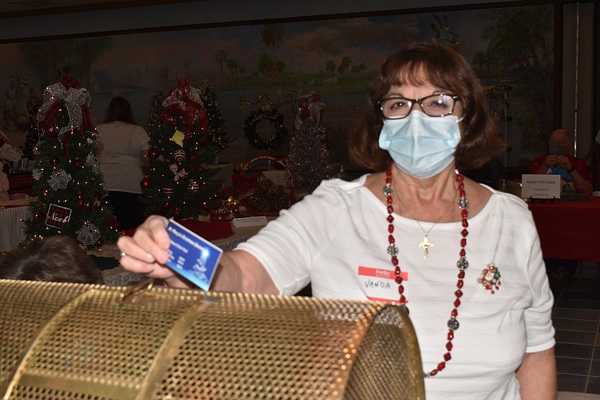 Vanda Soper drops a raffle ticket in.
