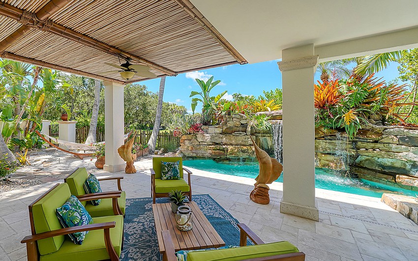 Lush landscaping surrounds the pool.