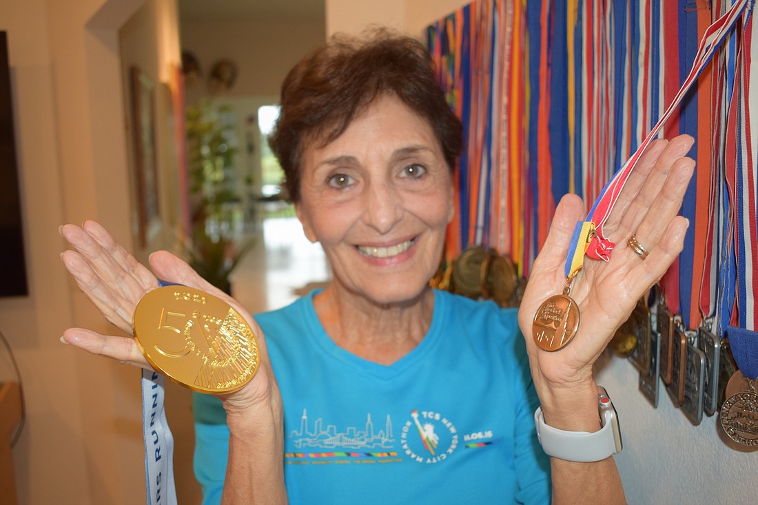 Connie Lyke-Brown shows off the medal she received Nov. 7 in the 50th New York City Marathon and the one in her first in 1978. She holds the record for most consecutive marathons by a woman in the New York City Marathon.