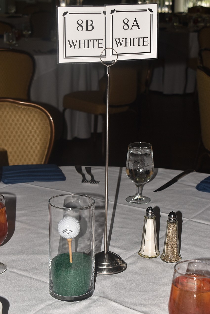 Each table was set with golf centerpieces.