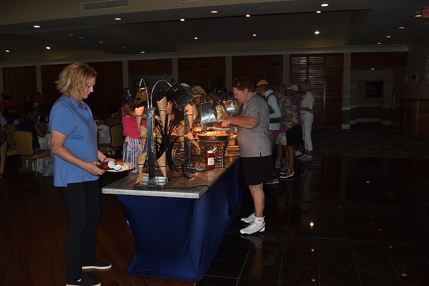 Golfers picked up lunch from a long buffet table.