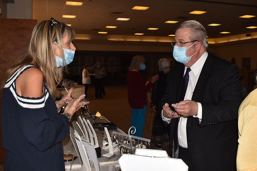 Ronetta Krause helps Rabbi Stephen Sniderman pick out jewelry.