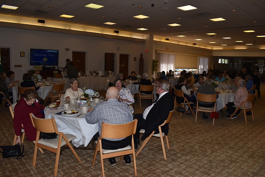 Tables of six sat down to eat together.