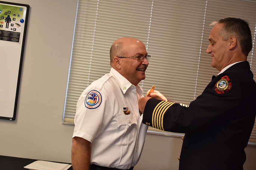 On Wednesday morning, Fire Chief Paul Dezzi (right) pinned John Elwood (left), who became a training captain.