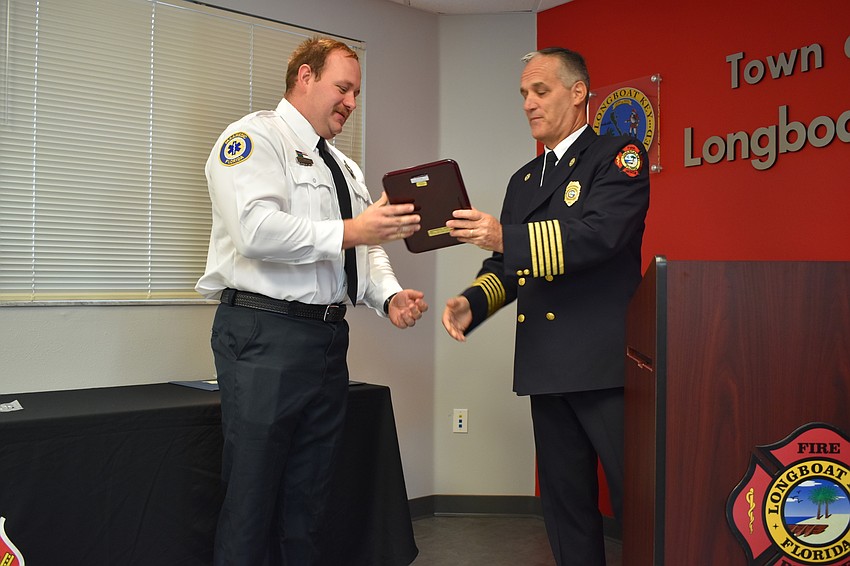 Firefighter-paramedic Chase Bullock gets recognized by Fire Chief Paul Dezzi on Wednesday morning. Bullock won the department’s employee of the year award.