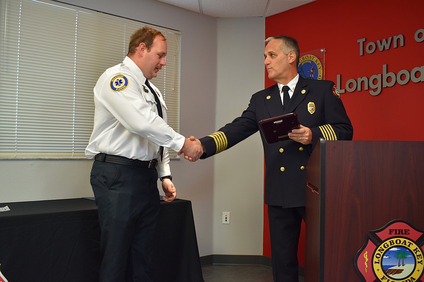 Firefighter-paramedic Chase Bullock gets recognized by Fire Chief Paul Dezzi on Wednesday morning. Bullock won the department’s employee of the year award.