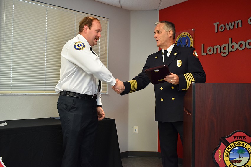 Firefighter-paramedic Chase Bullock gets recognized by Fire Chief Paul Dezzi on Wednesday morning. Bullock won the department’s employee of the year award.