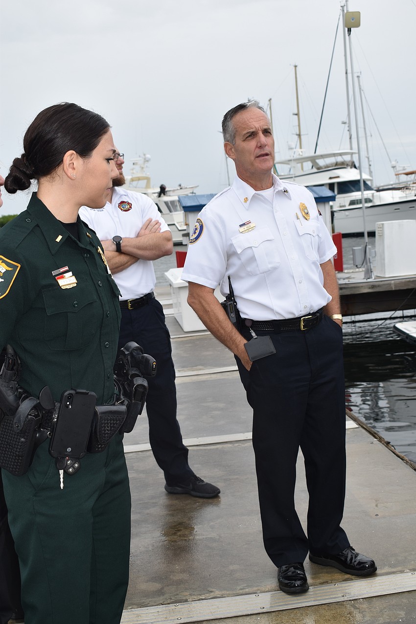 Fire Chief Paul Dezzi  (right)shows Sarasota County Sheriff's Office Lt. Michelle DiCapua (left) where the Longboat Key Fire Rescue Department stores its boat.